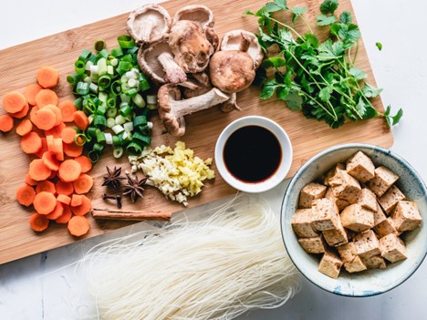 Close-up of various ingredients for a healthy dinner, a key part in maintaining a balanced lifestyle after moving. 